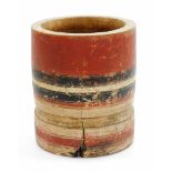 An African tribal jar, painted with a red and black banding, with plain interior, 18cm high.