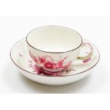 A porcelain cup and saucer, design of pink floral group, blue mark to underside, 11cm wide.