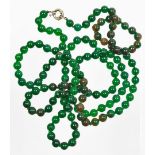 A string of jade coloured glass beads, each approx 4mm diameter, on a plain clasp, 116cm long.