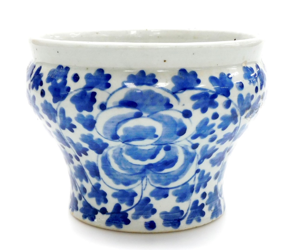 A late 19thC Chinese blue and white jardiniere, of waisted form painted with flowers and leaves,