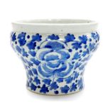 A late 19thC Chinese blue and white jardiniere, of waisted form painted with flowers and leaves,