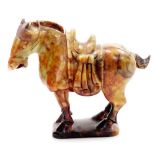 A Chinese soapstone Tang style figure of a standing saddled horse, on shaped base, 20cm high.
