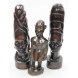 Tribal Art. Three wooden figures, comprising a lady and gentleman, each in head dress, on a block