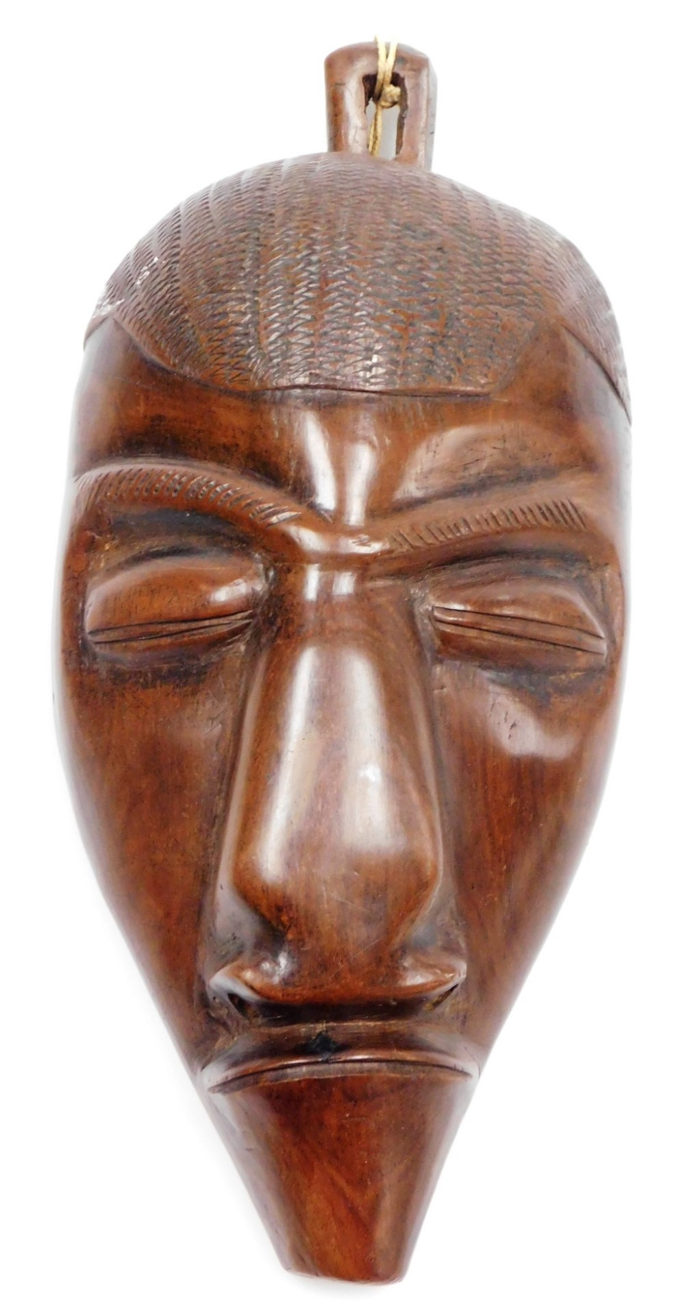 Tribal Art. A mahogany wall mask of a figure, 31cm high, 18cm wide.