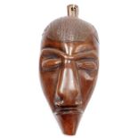 Tribal Art. A mahogany wall mask of a figure, 31cm high, 18cm wide.