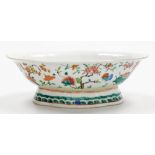 A 19thC Chinese porcelain dish, of shaped oval form and flared foot, in famille rose colours,