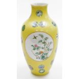 A 20thC Qianlong Imperial style porcelain vase, decorated with circular panels depicting birds in