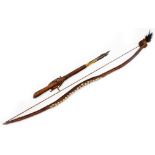 A South Sea style or tribal bow, with shaped handle set with shells and a turned leather section