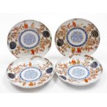 A set of four Japanese Imari porcelain plates, decorated with figures among bamboo and prunus,
