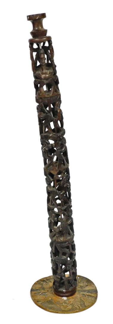 A 20thC African tribal carved pillar, of four sections formed as many figures with elaborate hair