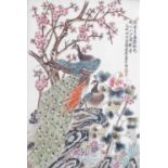 A Chinese Republic porcelain panel, painted with peacocks, prunus blossom and other flowers, with