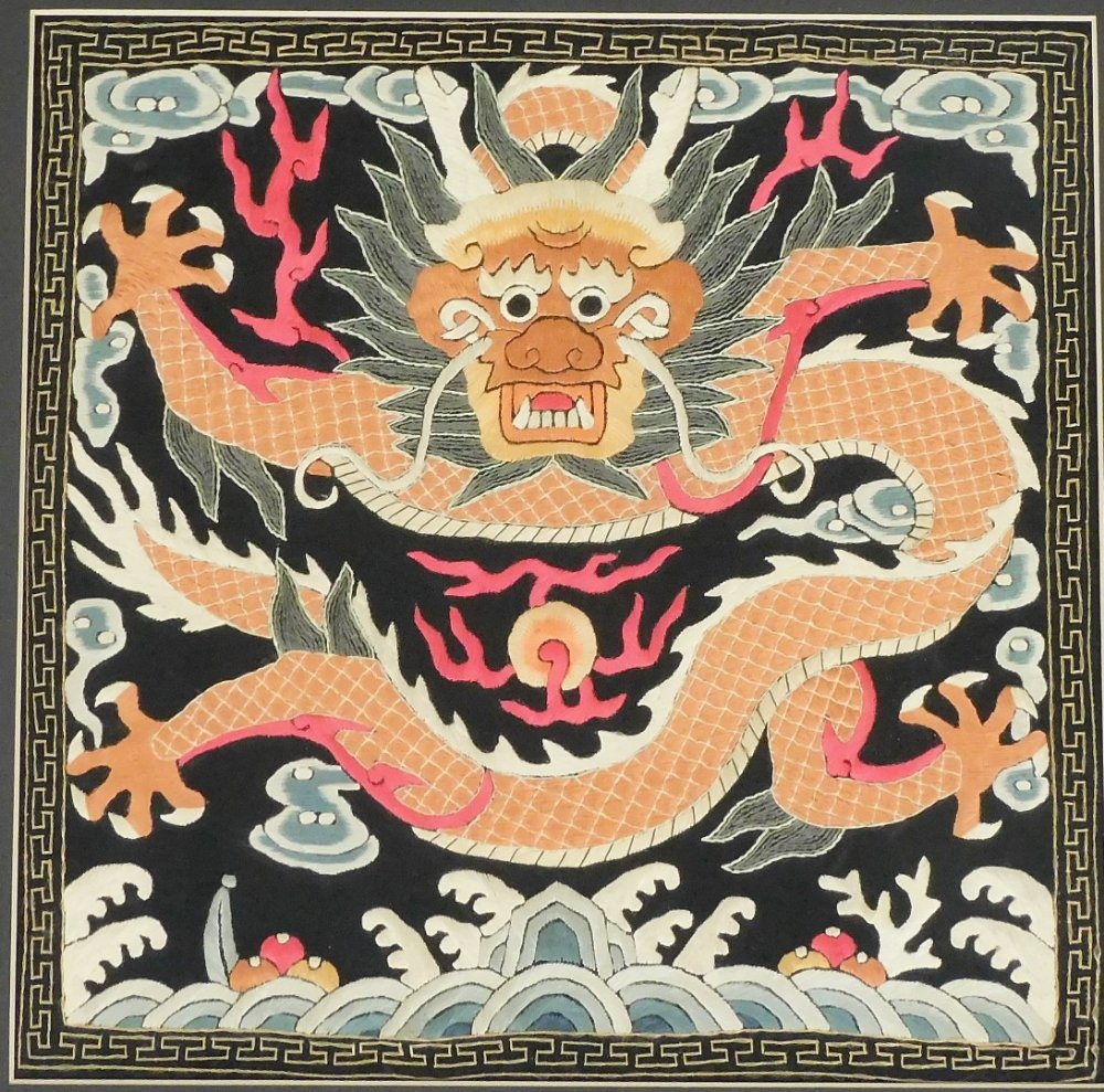 A pair of 20thC Chinese silk embroideries, in the style of rank badges depicting a dragon with - Image 3 of 3