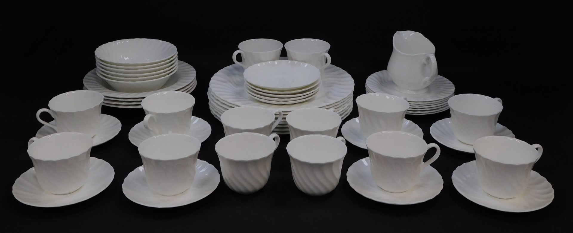 A Wedgwood white glazed semi fluted part dinner and tea service, printed marks, comprising eight