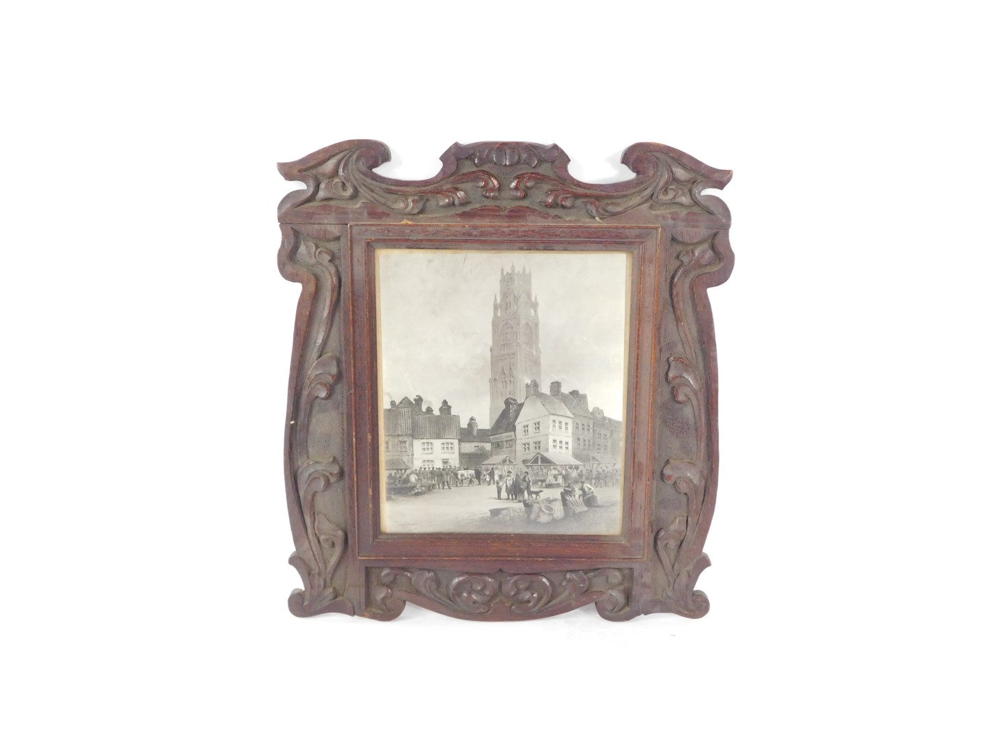 An Art Nouveau picture frame, carved with scrolling leaves, set with a print of the Boston Stump and