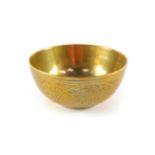 A Chinese polished bronze bowl, engraved externally with characters, 11cm diameter.