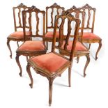 A set of six Continental late 19thC oak single dining chairs, with foliate carved crest rails,