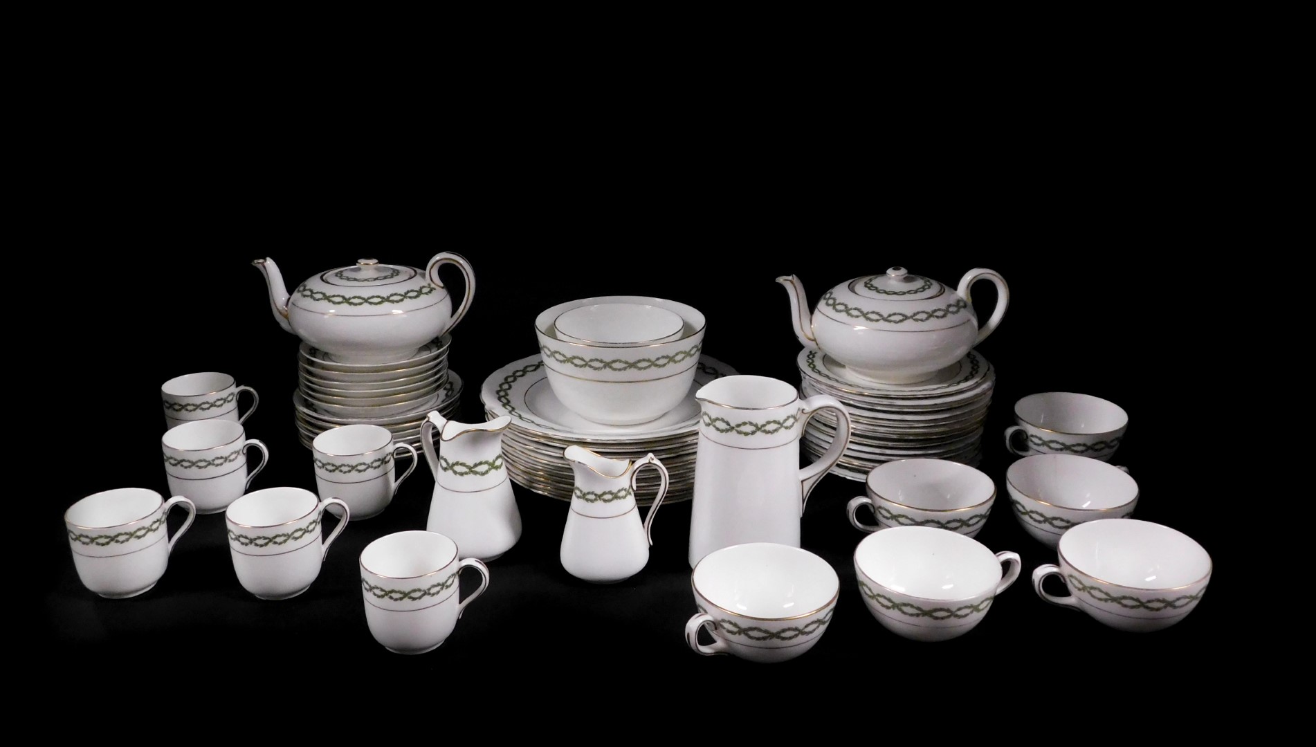 A Royal Doulton early 20thC porcelain tea and coffee service, decorated with a band of green