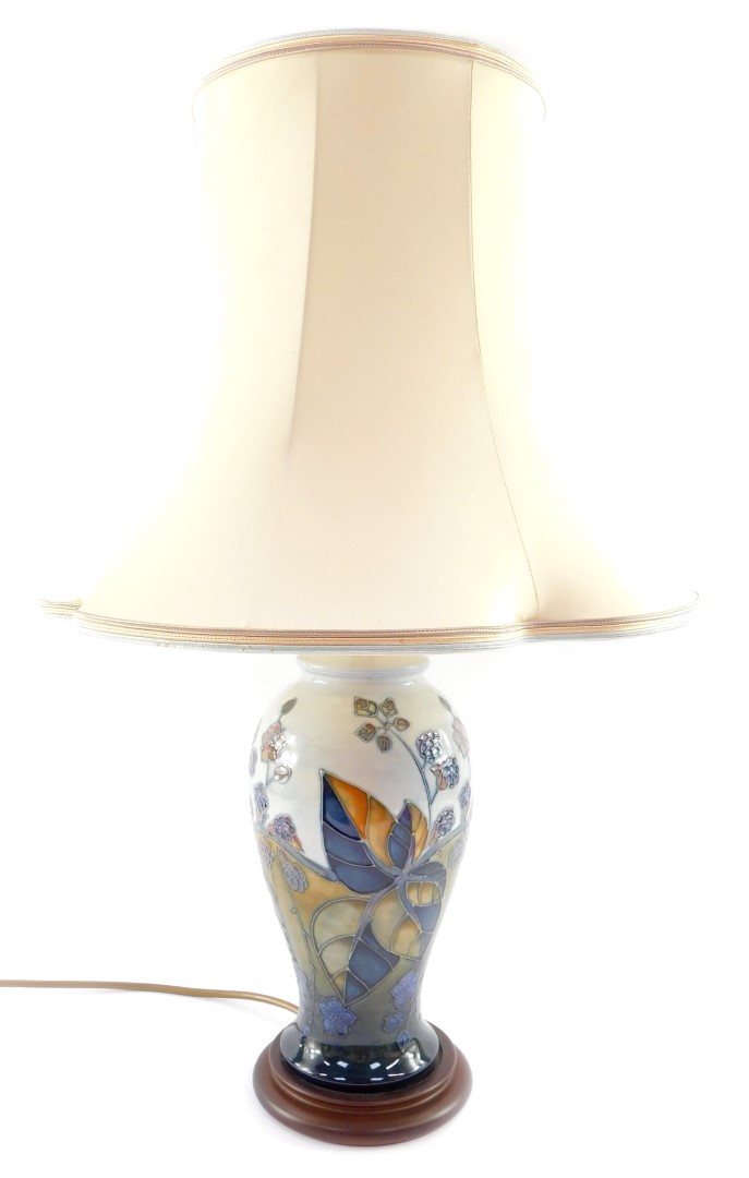 A Moorcroft Pottery table lamp decorated in the Blackberry Bramble pattern, of baluster form, raised