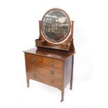 A Victorian Arts & Crafts style mahogany dressing chest, with a circular swing frame mirror, inset