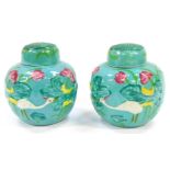 A pair of Chinese turquoise glaze ginger jars and covers, moulded in relief with birds and water