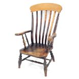 A Victorian beech and elm lath back kitchen chair, with solid saddle seat, raised on turned legs,