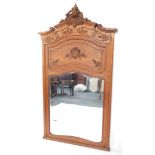 A Continental late 19thC oak overmantel mirror, carved with rococo foliate scrolls and flowers,