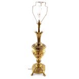 A brass table lamp, with embossed rococo scroll decoration, 74cm high.