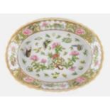 A Chinese Republic Cantonese famille rose oval porcelain dish, painted with flowers, butterflies,
