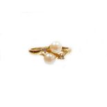 A faux pearl and imitation white stone set dress ring, of twist design on a yellow metal coloured ba