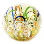 A mid 20thC glass paperweight, in colourful part ribboned decoration, 8cm high.