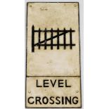 A cast iron railway sign for a level crossing, decorated with a crossing gate, etc., 59cm x 29cm.