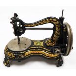 A Jones sewing machine, in black metal with gilt decoration, stamped Jones hand machine, 27cm high,