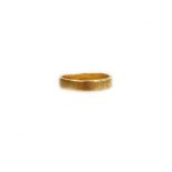 A 22ct gold wedding band, of plain design, makers stamp C and F, London 1980, ring size K ½, 3.5g.