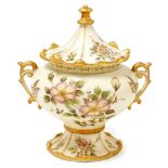 A porcelain comport, with overall cream decoration picked out in gilt, with decoration of flowers, w