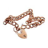 A 9ct rose gold charm bracelet, with curb link rose gold bracelet, with a heart shaped padlock with