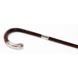 An early 20thC silver handled walking stick, the mahogany stick with a silver handle, with scroll d