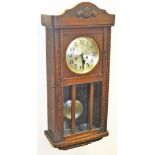 An early 20thC wall clock, with silvered dial, dial bearing two bear figures, in a moulded mahogany