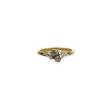 An Edwardian style dress ring, set with two tiny diamonds, in raised floral surround, with fern desi