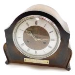 A 1950's oak cased mantel clock, with a circular dial, with a silver plaque inscribed presented to W