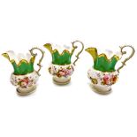 Three 19thC graduated porcelain jugs, each with green and yellow gilt design flared top, with painte