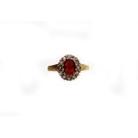 A 9ct gold dress ring, set with garnet and white stones, on shaped shoulders, ring size L, 2.8g all