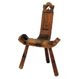 A rustic pine hall chair, with Gothic piercing, the back carved with a leaf.