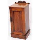 A Victorian walnut pot cupboard, with a raised back, and a moulded edge above a single panelled door