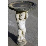 A reconstituted stone bird bath, with plinth modelled as a cherub, 68cm high.