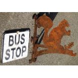 Two outdoor effects, to include a metal squirrel hanging basket bracket and a painted bus stop sign.