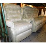 A two seater reclining sofa and matching armchair, upholstered in a cream and light green floral fab