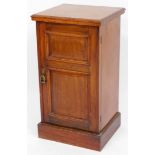 A late Victorian walnut pot cupboard, with a moulded edge above a double panelled door on a plinth,