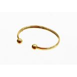 A 9ct gold torc bangle, of fold over two row twist design with ball terminals, stamped 375, 5.5cm di