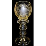 An early 20thC hock glass, the balloon bowl with grapevine and leaf decoration, on a baluster stem w