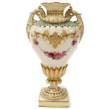 A Royal Worcester urnular vase, decorated in white, with pink and yellow roses, and a turquoise bord